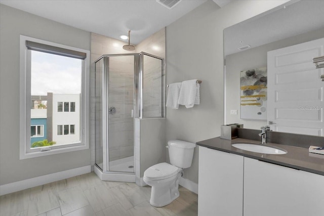 bathroom featuring walk in shower, vanity, and toilet