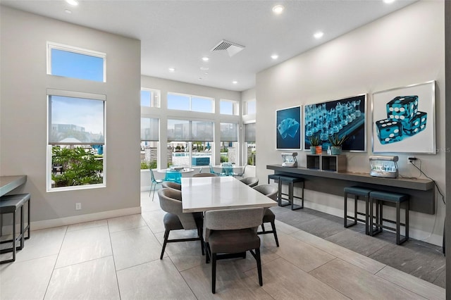 dining space featuring a towering ceiling