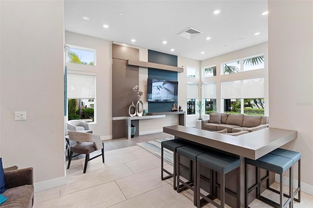 living room with light tile patterned floors and a wealth of natural light