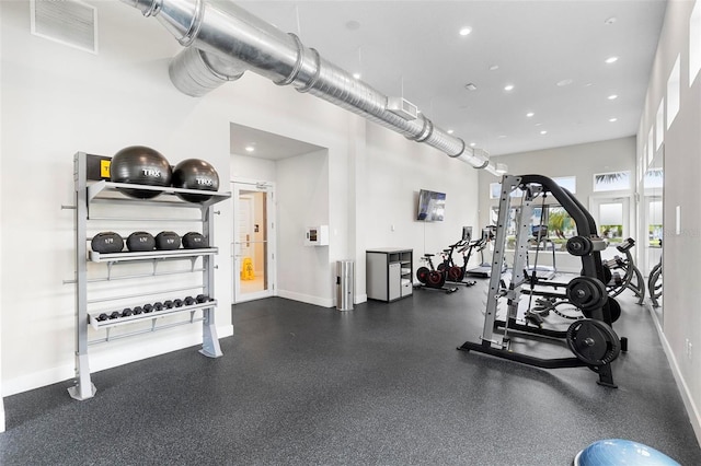 workout area with a towering ceiling