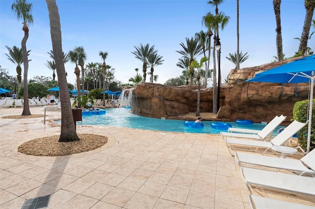 view of pool with a patio area and pool water feature