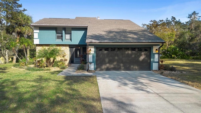 view of front facade with a garage and a front lawn