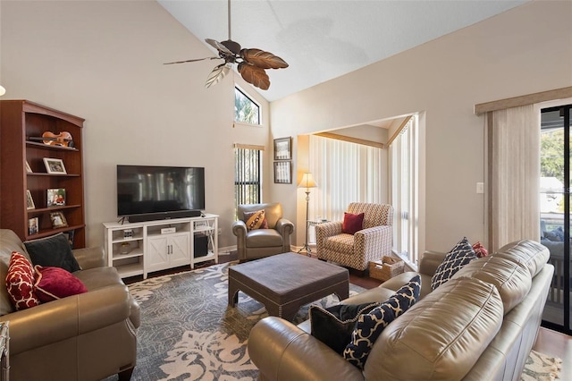 living room featuring hardwood / wood-style flooring, high vaulted ceiling, and ceiling fan