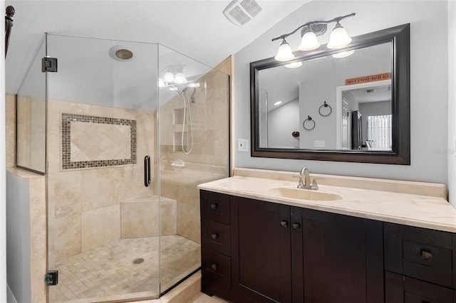 bathroom featuring vanity and a shower with door