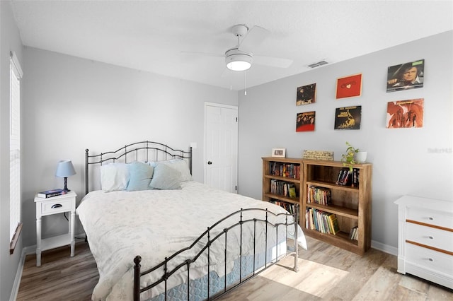 bedroom with ceiling fan and light hardwood / wood-style flooring