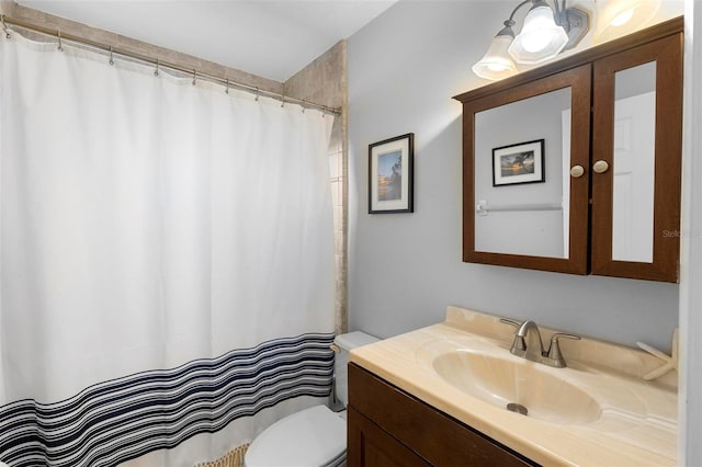 bathroom featuring vanity, toilet, and a shower with shower curtain