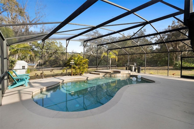 view of swimming pool with an in ground hot tub, glass enclosure, and a patio