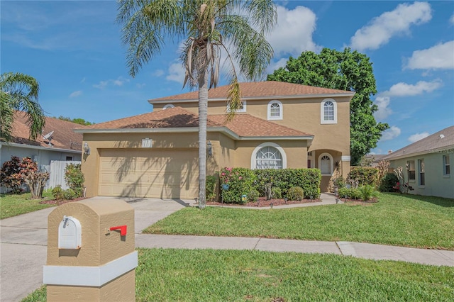 mediterranean / spanish-style house featuring a garage and a front lawn