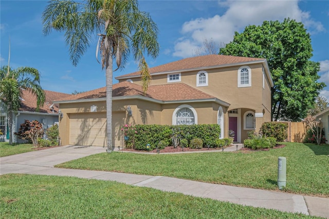 mediterranean / spanish home with a garage and a front lawn