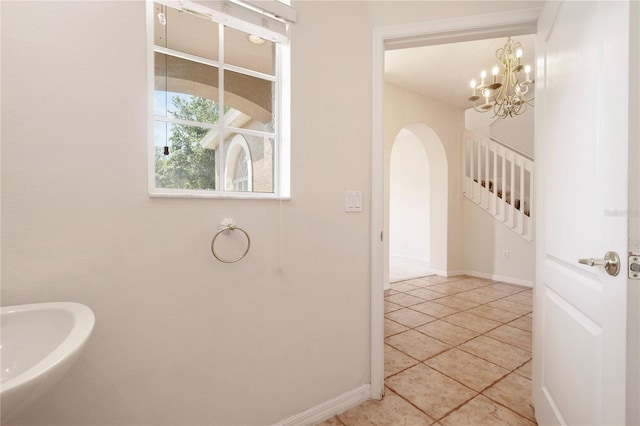 bathroom featuring tile patterned floors and a chandelier