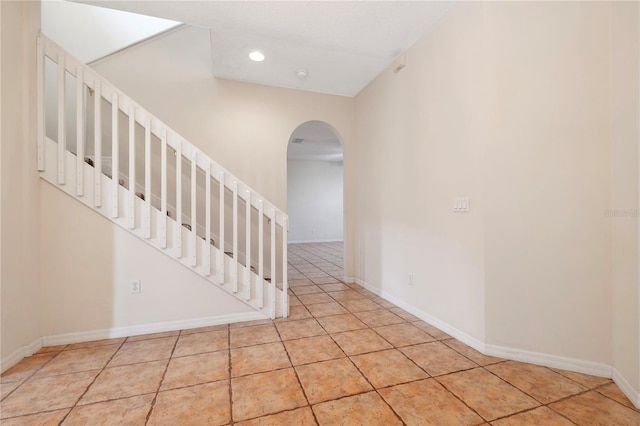 stairway with tile patterned floors