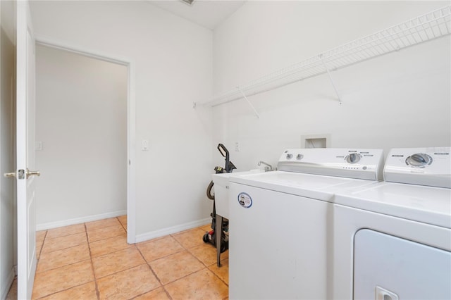 washroom featuring washer and dryer and light tile patterned floors