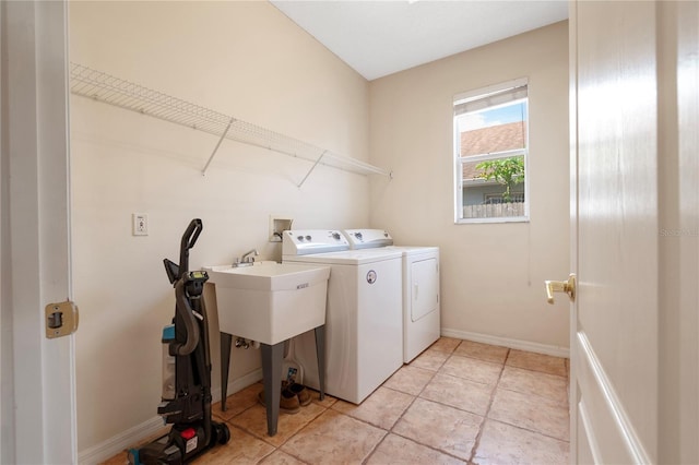 washroom with light tile patterned floors and washing machine and dryer