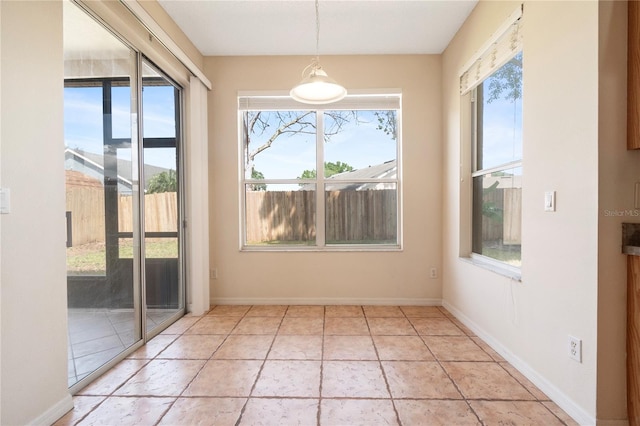 unfurnished dining area featuring light tile patterned floors