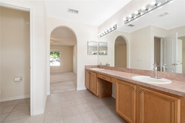 bathroom featuring tile patterned flooring and vanity