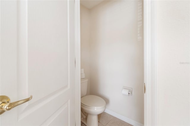 bathroom featuring tile patterned flooring and toilet