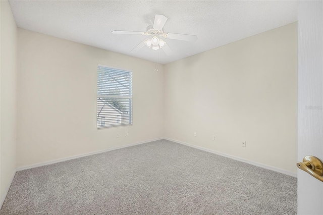 carpeted spare room featuring ceiling fan and a textured ceiling