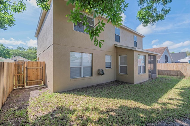 rear view of property with a lawn