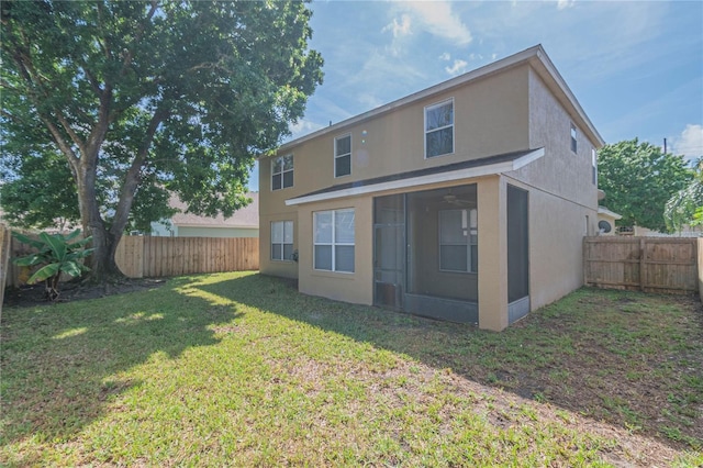 back of house with a lawn