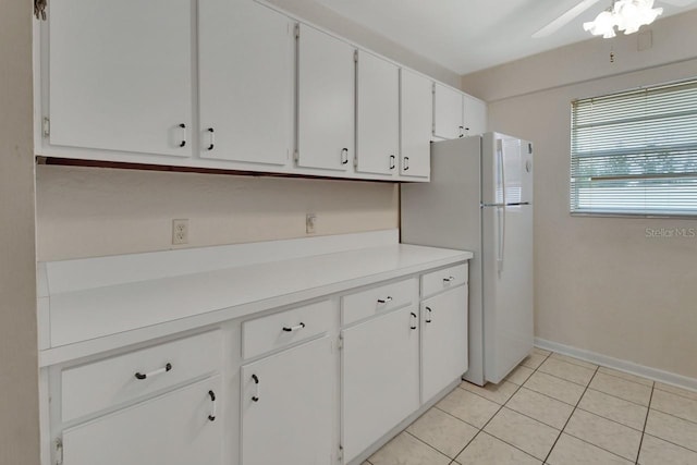 kitchen featuring white cabinetry, white fridge, light tile patterned floors, and ceiling fan