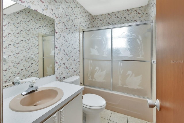 full bathroom featuring tile patterned floors, toilet, combined bath / shower with glass door, and vanity