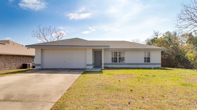 ranch-style house featuring a garage, central AC unit, and a front lawn