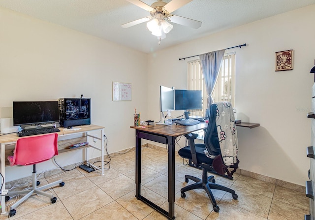 tiled office space featuring a textured ceiling and ceiling fan