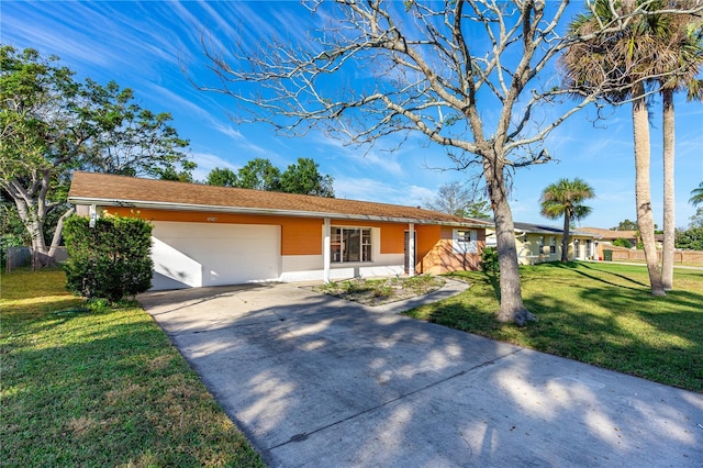 ranch-style house with a garage and a front lawn