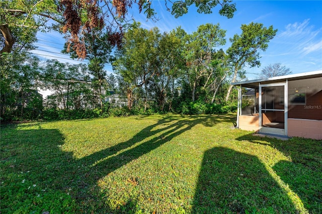 view of yard with a sunroom