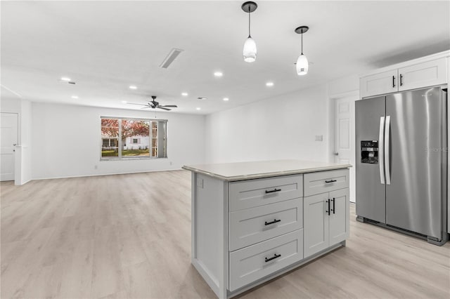 kitchen with light hardwood / wood-style flooring, ceiling fan, hanging light fixtures, a center island, and stainless steel fridge with ice dispenser