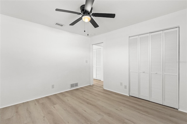 unfurnished bedroom with a closet, ceiling fan, and light wood-type flooring