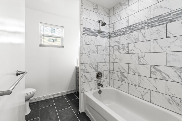 bathroom featuring tiled shower / bath combo, tile patterned floors, and toilet