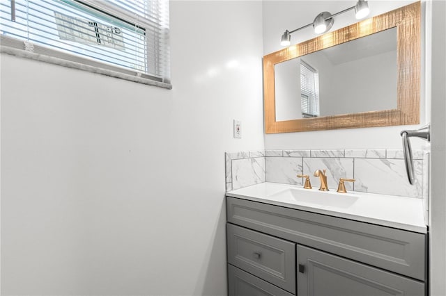 bathroom with tasteful backsplash and vanity