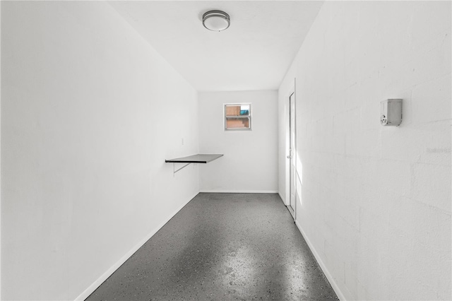 hallway with concrete floors