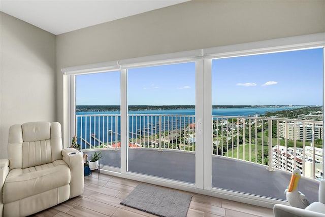 sunroom / solarium featuring a water view