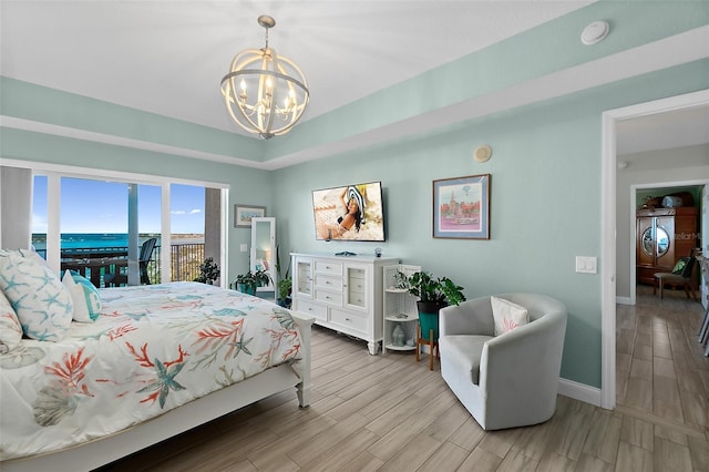 bedroom featuring light hardwood / wood-style flooring and a notable chandelier