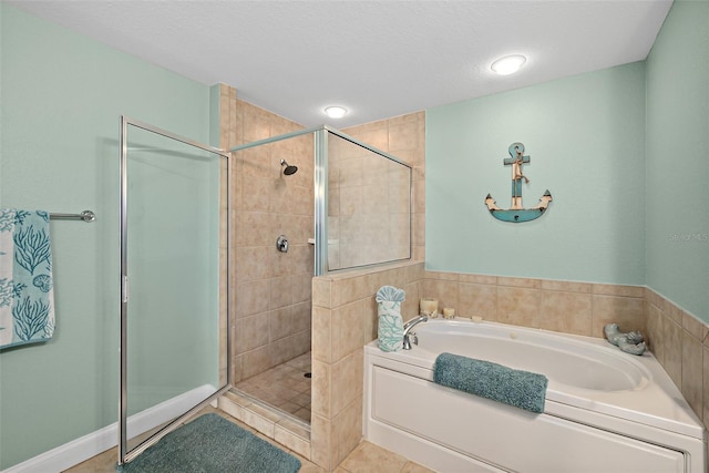 bathroom with tile patterned floors, shower with separate bathtub, and a textured ceiling