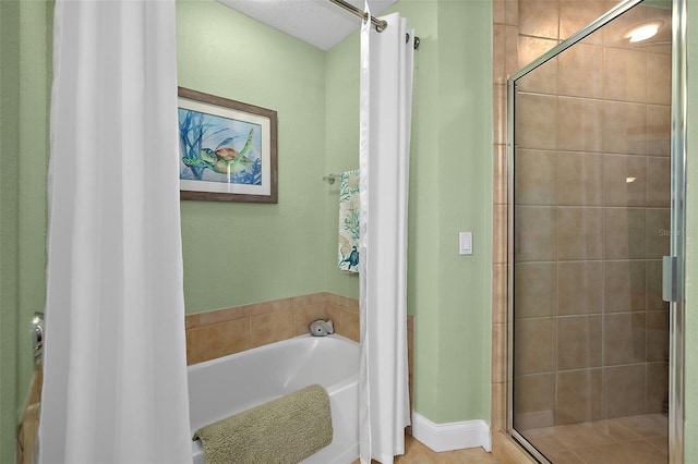 bathroom featuring shower with separate bathtub