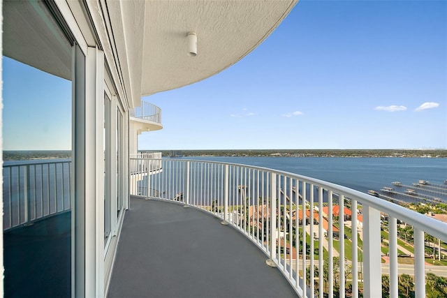 balcony featuring a water view