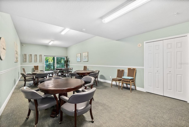 dining area featuring a textured ceiling and carpet