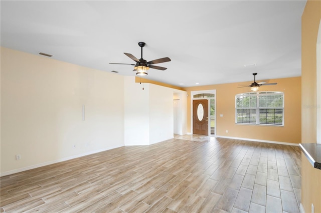 unfurnished living room with ceiling fan and light wood-type flooring