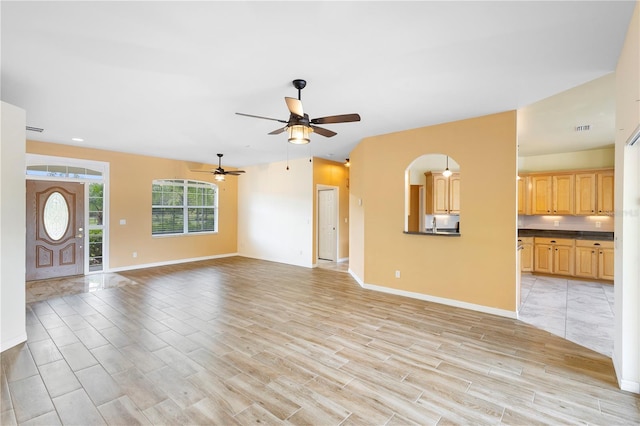 unfurnished living room with ceiling fan and light hardwood / wood-style flooring