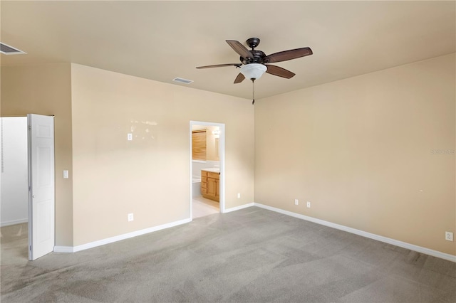 carpeted spare room featuring ceiling fan