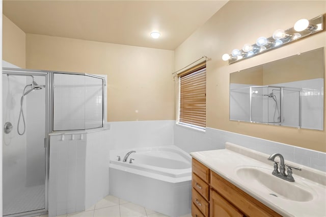 bathroom featuring vanity, tile patterned flooring, independent shower and bath, and tile walls