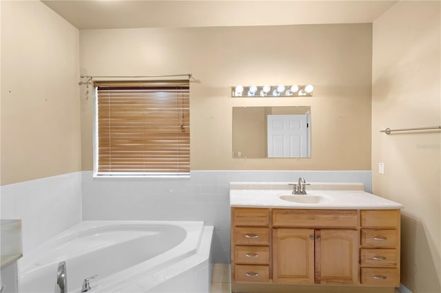 bathroom with vanity and tiled bath