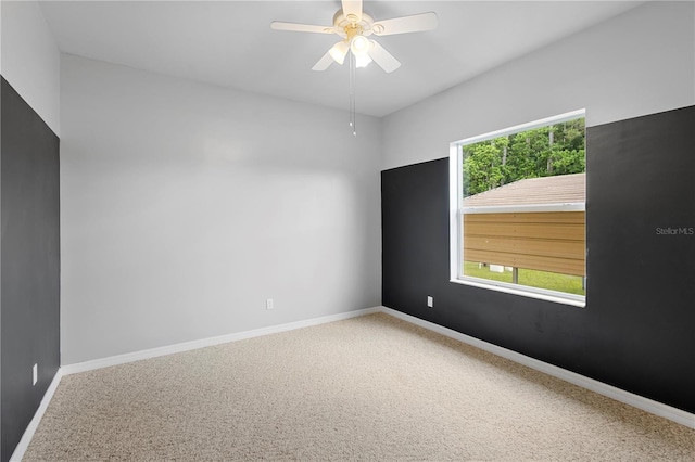 empty room with ceiling fan and carpet flooring