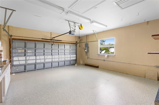 garage featuring a garage door opener and electric panel