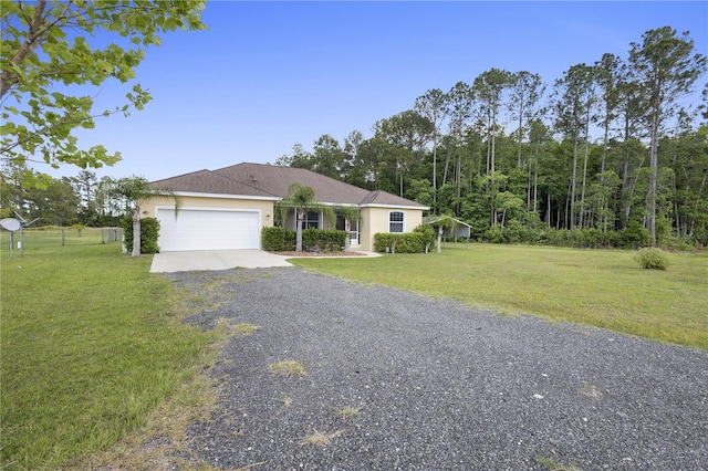 single story home featuring a garage and a front yard