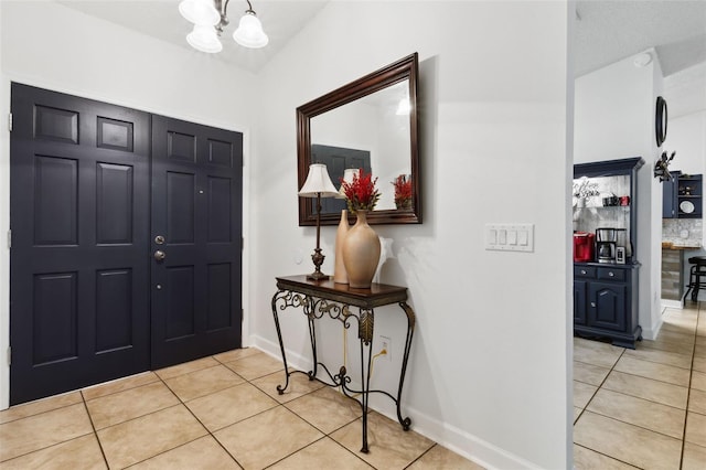 entryway featuring a chandelier and light tile patterned flooring