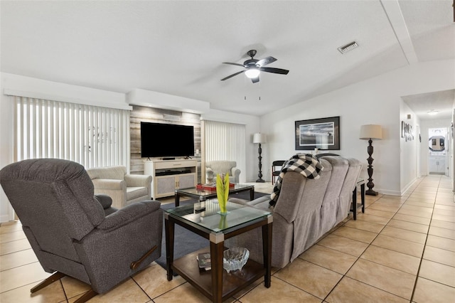 tiled living room featuring a healthy amount of sunlight, vaulted ceiling, and ceiling fan